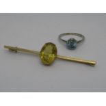 9ct Gold and citrine bar brooch together with a 9ct white gold blue zircon set ring