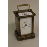 Small brass cased carriage clock with enamel dial and Roman numerals