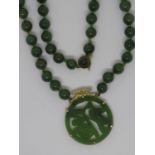 Chinese 14ct gold mounted jade pendant suspended from a bead necklace