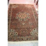 Tabriz rug having central medallion with all-over floral design on a wine ground with multiple