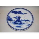 19th Century Imari blue and white charger decorated with a landscape scene, 18.25ins diameter,