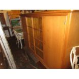 Mid 20th Century Continental oak side cabinet, the glazed centre door flanked by two panelled