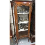 French kingwood ormolu mounted vitrine with a single door enclosing shelves raised on cabriole