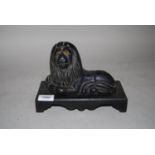 19th Century cast iron door stop in the form of a recumbent lion with glass eyes on a detachable