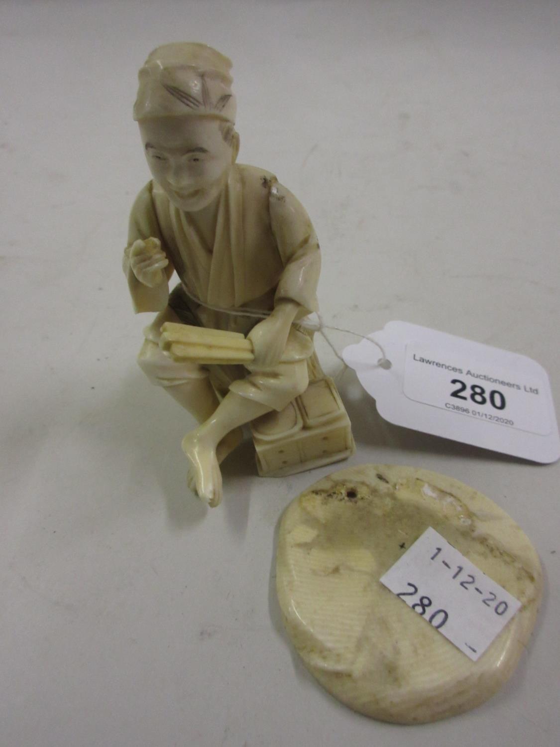 Small 19th Century Japanese carved ivory figure of a seated tradesman, red seal mark to base (at