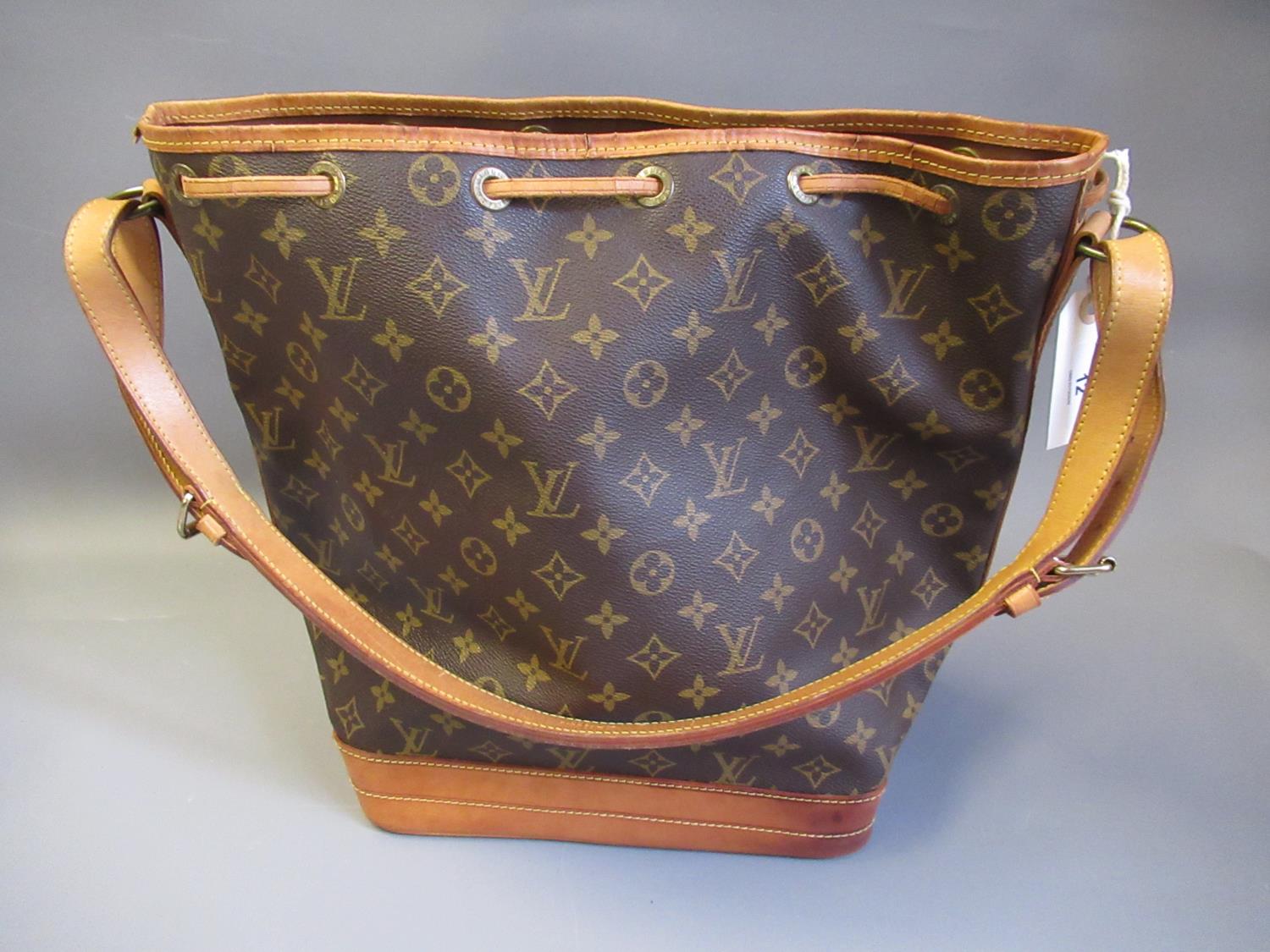 Louis Vuitton, ladies bucket bag with leather strap and leather tie top