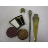 Antique brass and steel tongue scraper in original case, a small French gilt bronze medallion in a
