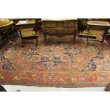 Antique Heriz carpet with a typical medallion and all-over stylised floral design on a brick red