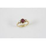 A RUBY AND DIAMOND THREE STONE RING the oval-shaped cabochon ruby is set with two single-cut