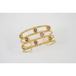 A CITRINE, QUARTZ AND GOLD BANGLE BY LALAOUNIS the 18ct gold openwork bangle is mounted with