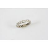 A DIAMOND ETERNITY RING mounted with circular-cut diamonds. Size O