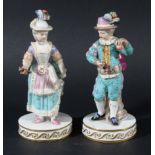 PAIR OF MEISSEN FIGURES, 19th century, modelled as a young couple, on circular bases, blue crossed