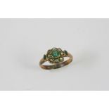 A VICTORIAN EMERALD AND PEARL RING set with three graduated emeralds and half pearls, in gold.