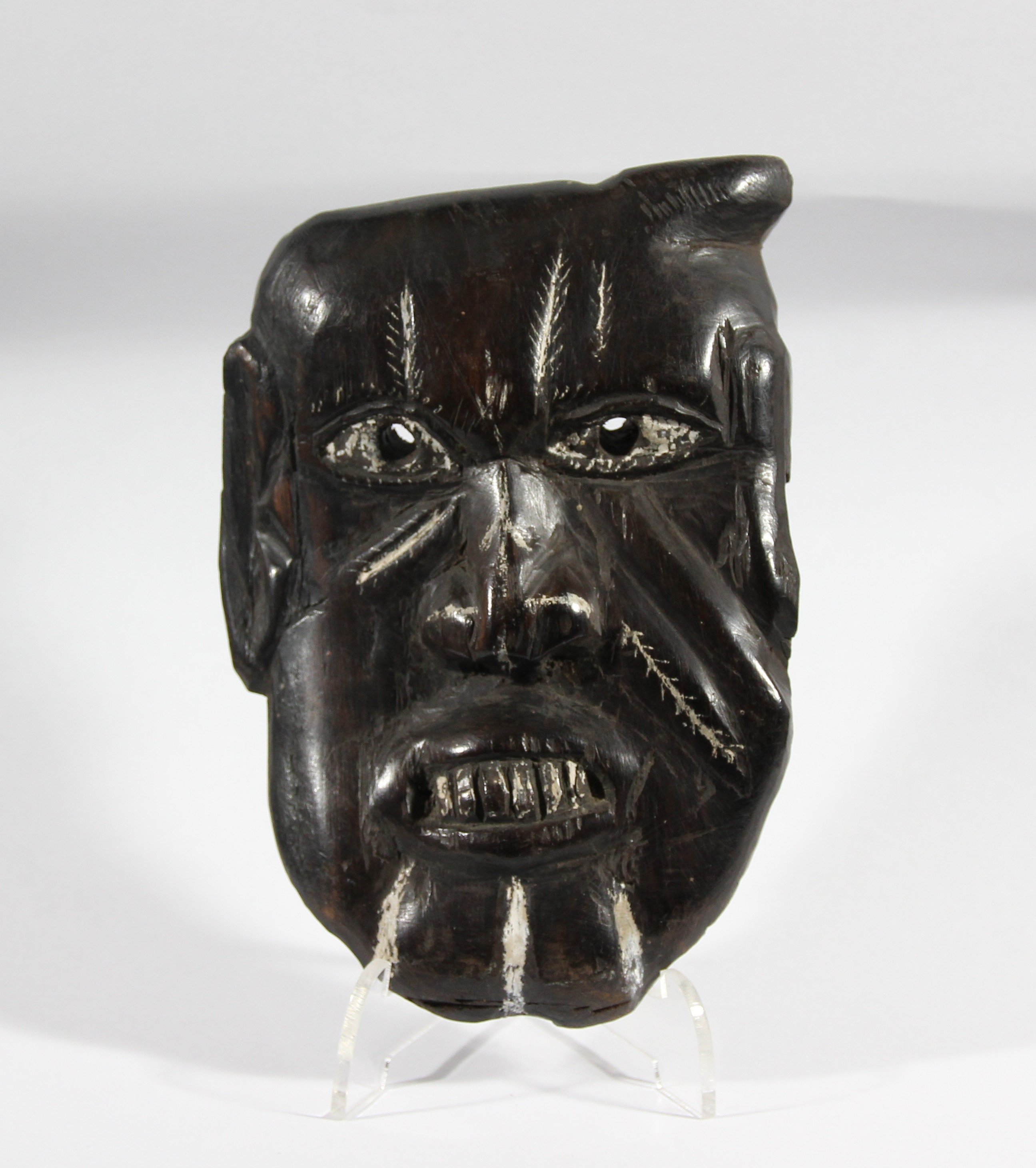 SOUTH SEA ISLANDS, an iron wood mask with white painted highlights, height 14cm
