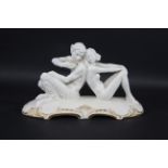 HUTSCHENREUTHER ART DECO FIGURE GROUP a white glazed figure of Pan playing a flute, seated next to