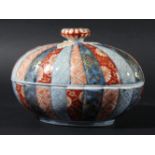 IMARI TUREEN AND COVER, probably Chinese, of ribbed oval form, painted with alternating bands of