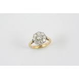 A DIAMOND CLUSTER RING the brilliant-cut diamond is set within a surround of eight smaller
