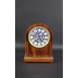 AESTHETIC MOVEMENT MANTLE CLOCK with a floral pottery dial and mahogany case, and with turned wooden