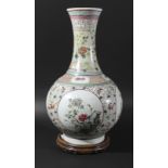 CHINESE FAMILLE ROSE BOTTLE VASE, 19th century, enamelled with four roundels of vases and flowers