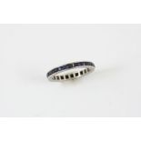 A SAPPHIRE FULL CIRCLE ETERNITY RING mounted with calibre-cut sapphires in white gold. Size P 1/2