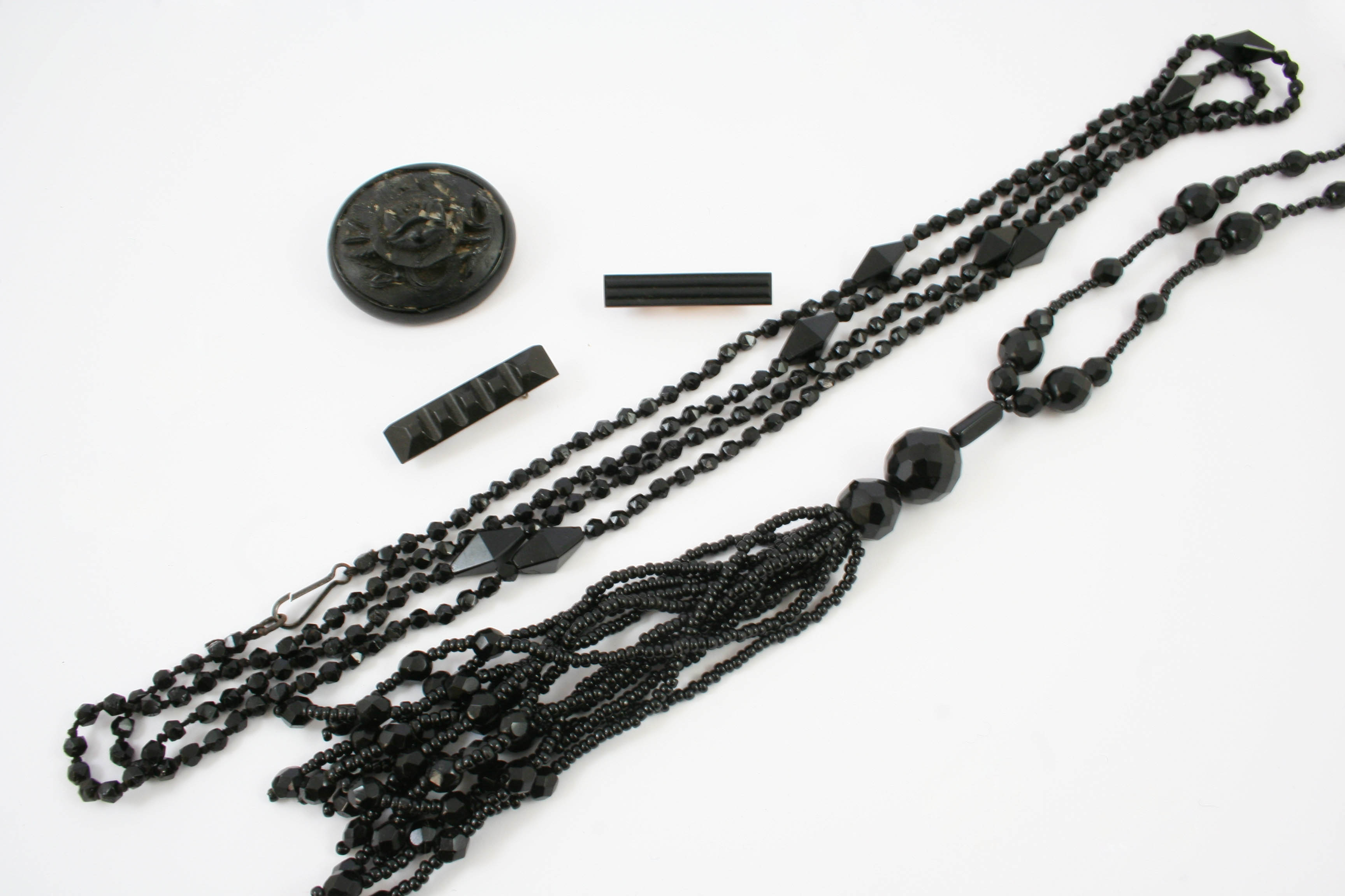 A QUANTITY OF JET JEWELLERY including a long tassel necklace, another necklace etc