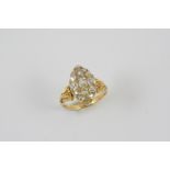 A DIAMOND MARQUISE-SHAPED CLUSTER RING set overall with graduated cushion-shaped old brilliant-cut