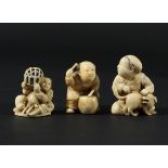 THREE JAPANESE IVORY NETSUKE, later 19th century, to include a man playing a drum, another with a