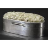 CHINESE CELADON JADE MOUNTED SILVER BOX, the oval plaque carved and pierced with a scrolling