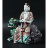 JAPANESE KUTANI FIGURE OF GUANYIN, seated on a guardian lion, height 25cm