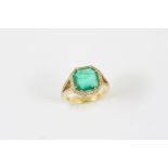 AN EMERALD AND DIAMOND CLUSTER RING the octagonal-shaped emerald is set within a surround of