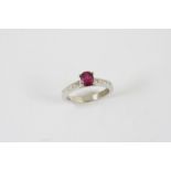 A RUBY AND DIAMOND RING the oval-shaped ruby is set with five baguette-cut diamonds to each