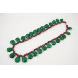 AN EMERALD AND RUBY NECKLACE formed with a ruby bead necklace suspending pear-shaped emerald