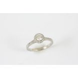 A DIAMOND SOLITAIRE RING the round brilliant-cut diamond is set within a surround of circular-cut