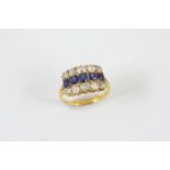 A SAPPHIRE AND DIAMOND THREE ROW RING set with five graduated oval-shaped sapphires within a