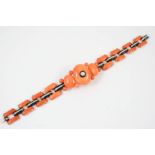AN ART DECO CORAL, BLACK ONYX AND DIAMOND BRACELET formed with oval-shaped coral, the centre one