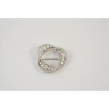 A DIAMOND BROOCH of scrolling form and set overall with graduated circular brilliant-cut diamonds,