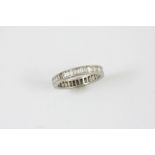 A DIAMOND FULL CIRCLE ETERNITY RING mounted with baguette-cut diamonds, in white gold. Size O 1/2