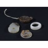 CHINESE NEAR WHITE JADE ARCHERS RING, together with three bi discs carved with chilong, 4.5cm and