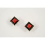 A PAIR OF CORAL, BLACK ONYX AND DIAMOND EARRINGS the square-shaped coral is set within a surround of