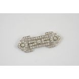 AN ART DECO DIAMOND BROOCH mounted with three old brilliant-cut diamonds, within an openwork