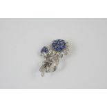 A SAPPHIRE AND DIAMOND FOLIATE SPRAY BROOCH the flowerheads mounted with circular-cut sapphires