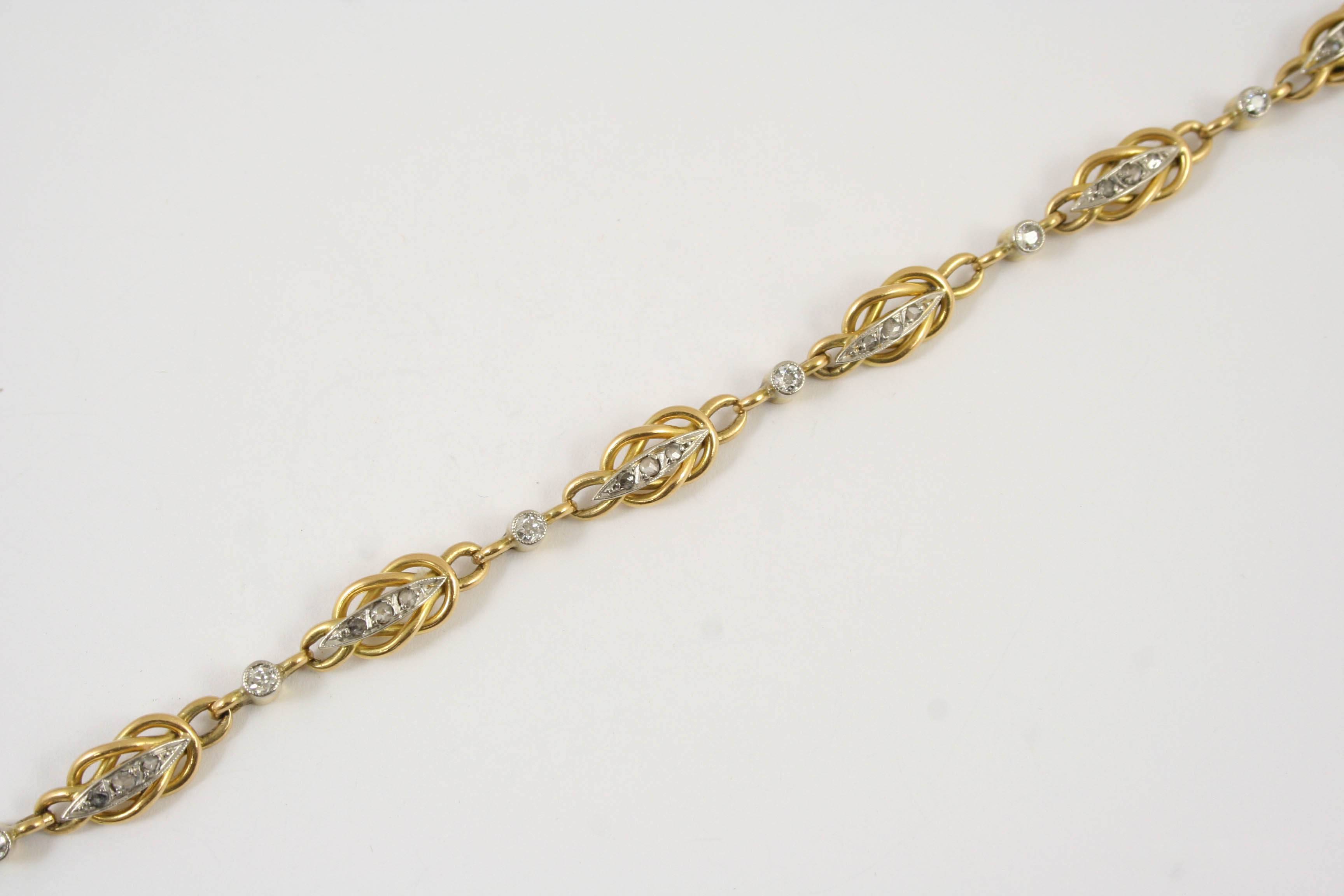 A FRENCH DIAMOND AND GOLD BRACELET the gold fancy link bracelet is mounted with rose-cut and