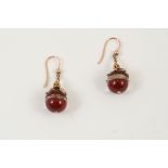 A PAIR OF CORNELIAN DROP EARRINGS each formed with two sections of cornelian separated by a