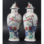 PAIR OF CHINESE FAMILLE ROSE VASES AND COVERS, 19th century, of inverted baluster form, enamelled