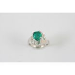 AN EMERALD AND DIAMOND RING the square-shaped emerald is set with a baguette-cut and three