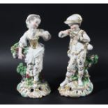 PAIR OF DERBY FIGURES, early 19th century, she with a basket of grapes, he with a garland of