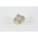 A DIAMOND CLUSTER RING the marquise-cut diamond is set within a surround of circular-cut diamonds,