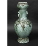 LARGE THEODORE DECK VASE of oriental influence with 2 mask handles with rings, with a celadon