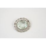 A BELLE EPOQUE AQUAMARINE AND DIAMOND BROOCH the oval-shaped aquamarine is set within an openwork