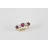 A RUBY AND DIAMOND FIVE STONE RING the three graduated circular-cut rubies are set with two